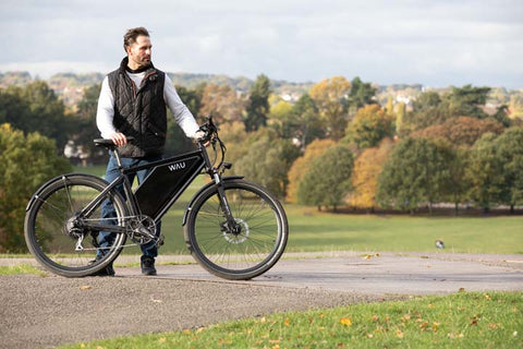 man with WAU bike in park